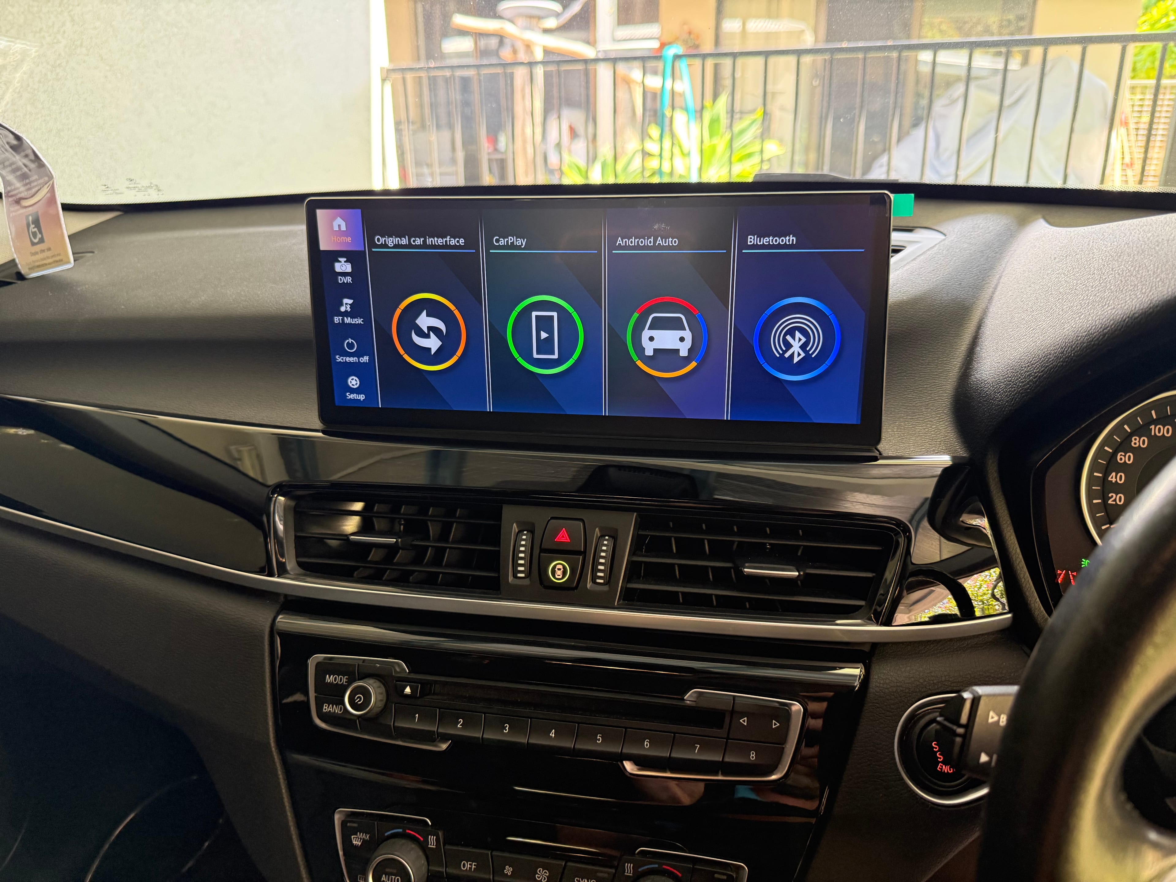 Technician fitting a new head unit into a car dashboard