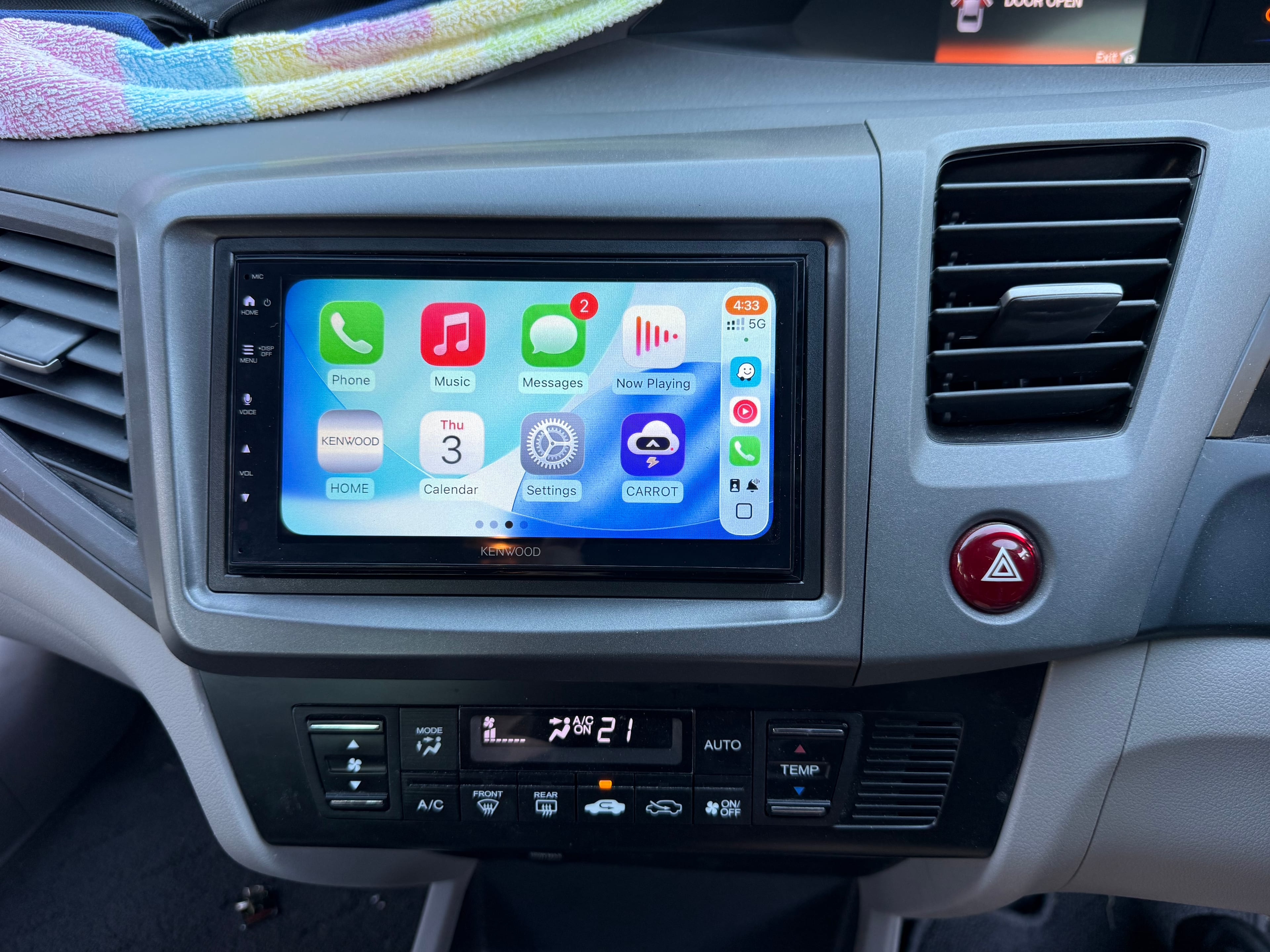 Technician wiring a car head unit installation
